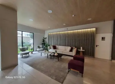 a living room with a couch and some chairs at María Paz Home in Lima