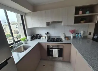 a kitchen with a sink and a stove top oven at María Paz Home in Lima