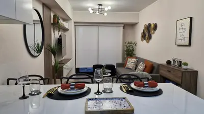 a living room with a table with plates and glasses at Departamento en Barranco - Like at Home in Lima