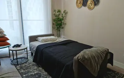 a bedroom with a bed and a table with a plant at Departamento en Barranco - Like at Home in Lima