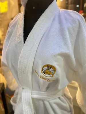 a man wearing a white jacket with a logo on it at Lama Vista Living 202 in Cusco