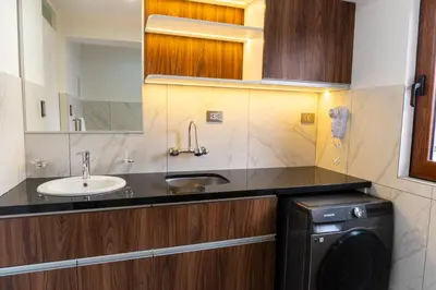 a bathroom with a sink and a washing machine at Lama Vista Living 202 in Cusco