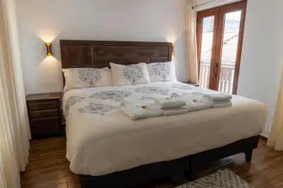 a bedroom with a bed with towels on it at Lama Vista Living 202 in Cusco
