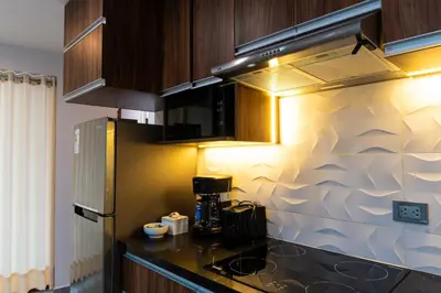 a kitchen with a black counter top and a refrigerator at Lama Vista Living 202 in Cusco