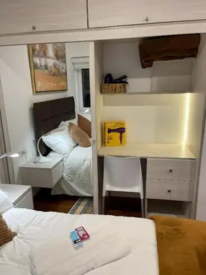 a room with a bed and a desk in a room at Av arequipa 603B in Lima
