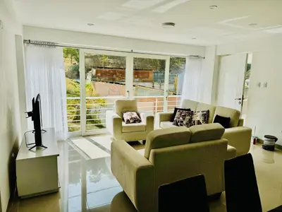 a living room with two couches and a television at Hermoso depa a 10 min del Centro de Huancayo in Huancayo