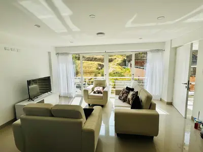 a living room with two couches and a tv at Hermoso depa a 10 min del Centro de Huancayo in Huancayo