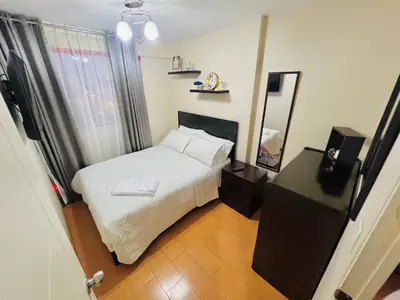 a small bedroom with a bed and a mirror at Apartamento en Santiago de Surco in Lima