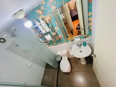 a bathroom with a sink and a toilet and a mirror at Apartamento en Santiago de Surco in Lima