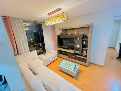a living room with a white couch and a tv at Apartamento en Santiago de Surco in Lima