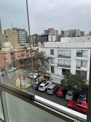 a view of a parking lot with cars in a city at Departamento en Miraflores, Lima in Lima