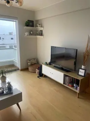 a living room with a large flat screen tv at Departamento en Miraflores, Lima in Lima