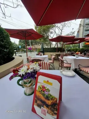 a table with a white table cloth with flowers on it at Moderno departamento San Isidro in Lima