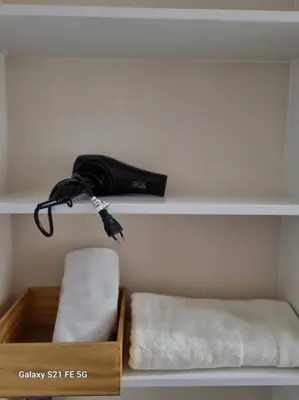 a shelf with a bag and a box with towels at Moderno departamento San Isidro in Lima