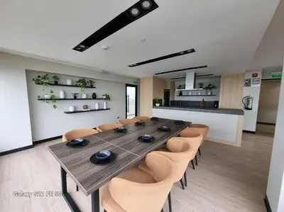 a long wooden table and chairs in a room at Moderno departamento San Isidro in Lima