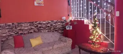 a living room with a couch and a christmas tree at Departamento con Cochera gratuita dentro de Instalaciones 8p Tierra del Sol Eterno Ica centro in Ica