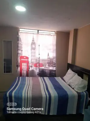 a bedroom with a bed with a view of london at 201 Comfy Apt WiFi kitchen SmartTV Central at Callao in Lima