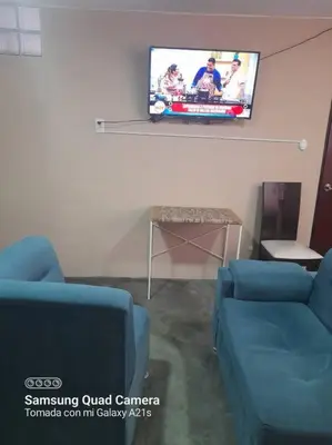a living room with two blue couches and a tv at 201 Comfy Apt WiFi kitchen SmartTV Central at Callao in Lima