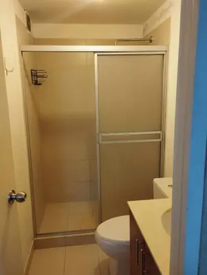 a bathroom with a shower with a toilet and a sink at Private Apartament in LINCE near MIRAFLORES & REBAGLIATI HOSPITAL with POOL, GYM, PRIVATE PARK ! in Lima