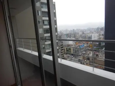 a balcony with a view of a city at Private Apartament in LINCE near MIRAFLORES & REBAGLIATI HOSPITAL with POOL, GYM, PRIVATE PARK ! in Lima