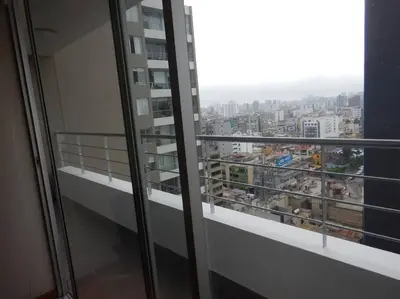 a balcony with a view of a city at Private Apartament in LINCE near MIRAFLORES & REBAGLIATI HOSPITAL with POOL, GYM, PRIVATE PARK ! in Lima