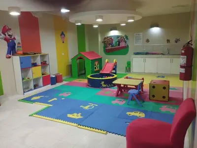 a childrens play room with a table and a playground at Private Apartament in LINCE near MIRAFLORES & REBAGLIATI HOSPITAL with POOL, GYM, PRIVATE PARK ! in Lima