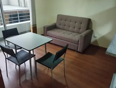a living room with a table and chairs and a couch at Private Apartament in LINCE near MIRAFLORES & REBAGLIATI HOSPITAL with POOL, GYM, PRIVATE PARK ! in Lima