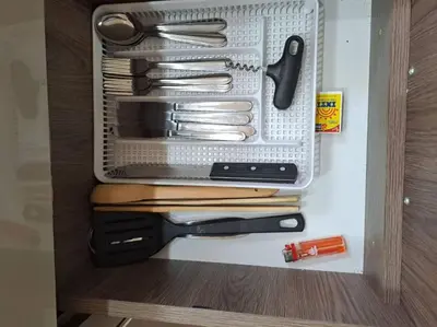 a drawer full of utensils in a cabinet at Departamento INTI - casa de Teresita in Cusco