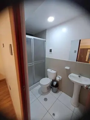 a bathroom with a toilet and a sink at Departamento INTI - casa de Teresita in Cusco