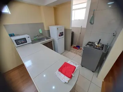 a small kitchen with a stove and a counter top at Departamento INTI - casa de Teresita in Cusco