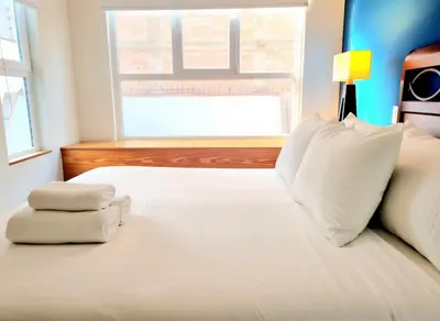 a white bed with two towels on top of it at E SuiteTOP Tudela San Isidro Lima 2B 202 in Lima