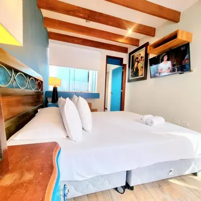 a bedroom with a large bed with white sheets at E SuiteTOP Tudela San Isidro Lima 2B 202 in Lima