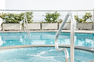 a swimming pool with a ladder in the water at Wyndham Costa del Sol Lima City in Lima
