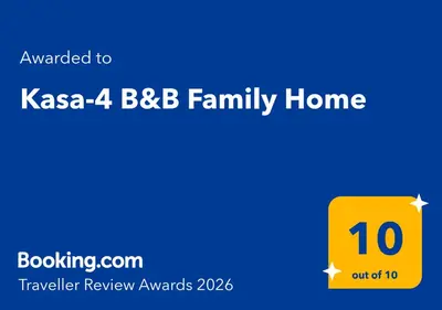 a yellow house number with the text awarded to kasa bbb family home at Kasa-4 B&B Family Home in Huancayo