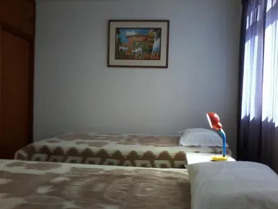 a bedroom with a bed and a picture on the wall at Royal Sweet Dreams Airport B&B in Lima
