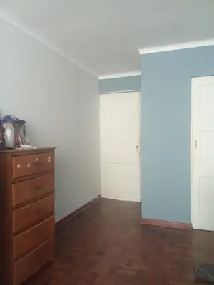 an empty room with two white doors and a dresser at Cristal in Lima