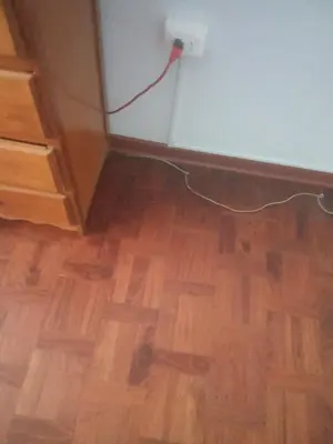 a room with a hard wood floor and an electrical outlet at Cristal in Lima
