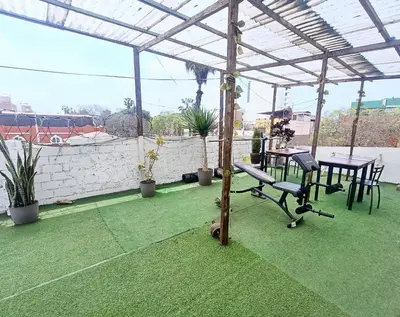a patio with a bench and a table on a roof at Casa Turística Monumental in Lima