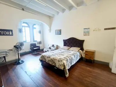 a bedroom with a bed and a desk in it at Casa Turística Monumental in Lima