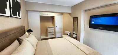 a bedroom with a bed and a flat screen tv at Hermoso Departamento Miraflores in Lima