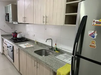 a kitchen with a sink and a refrigerator at Departamento de 04 dormitorios in Lima