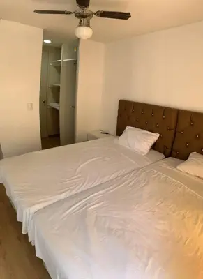 a bedroom with a large white bed with a headboard at Departamento de 04 dormitorios in Lima