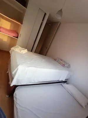a room with two beds in a small room at Departamento de 04 dormitorios in Lima