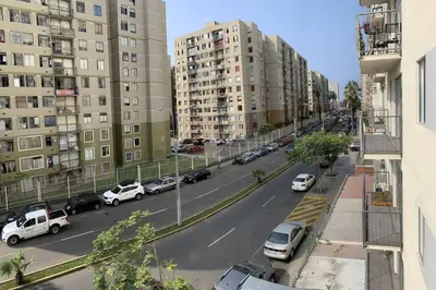 a view of a city street with parked cars and buildings at Departamento de 04 dormitorios in Lima