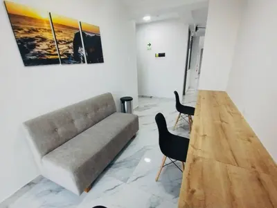 a living room with a couch and two chairs at Costanera Hotel in Minas de Marcona