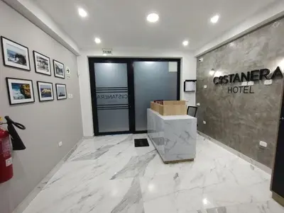 a lobby of a casenna hotel with a sign on the wall at Costanera Hotel in Minas de Marcona