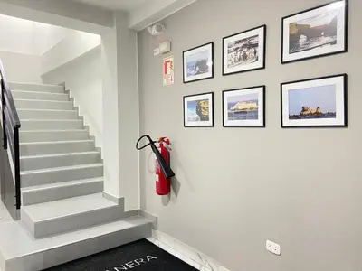 a hallway with stairs and pictures on the wall at Costanera Hotel in Minas de Marcona