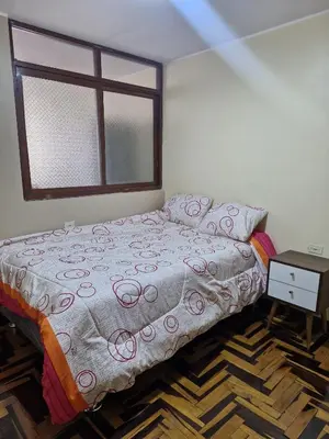 a bedroom with a bed and a window at Apartamento-Santa Anita, Villa Caly in Lima