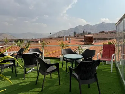 a group of chairs and tables on a roof at Hotel Plateros in Cusco