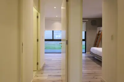 a hallway with a room with a bed and a window at Aldea 3BR Chic Bay Hideaway in Paracas